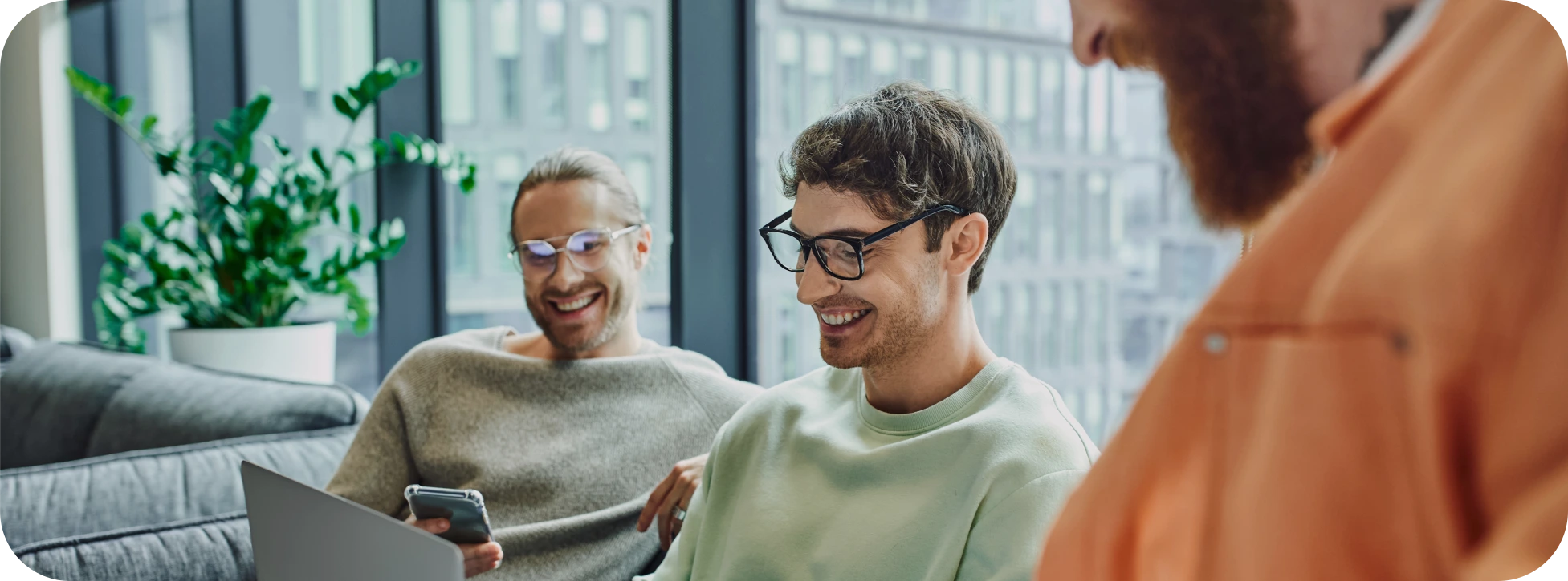 Team discussing voice OTP delivery results on a laptop.